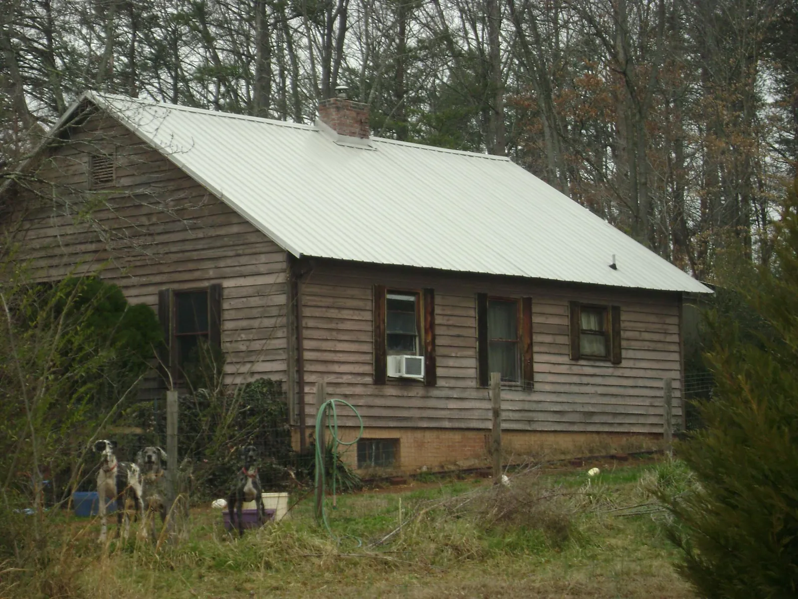 White metal roof on an old wood sided farmhouse, from a Metal Roof Installation job in Ashaway